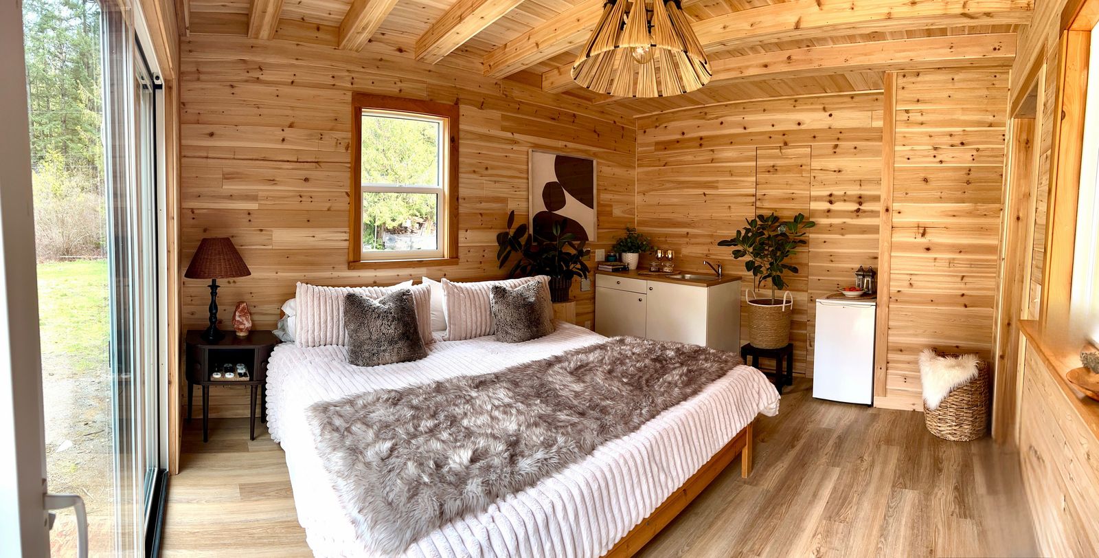 A king bed inside the cedar-lined cabin