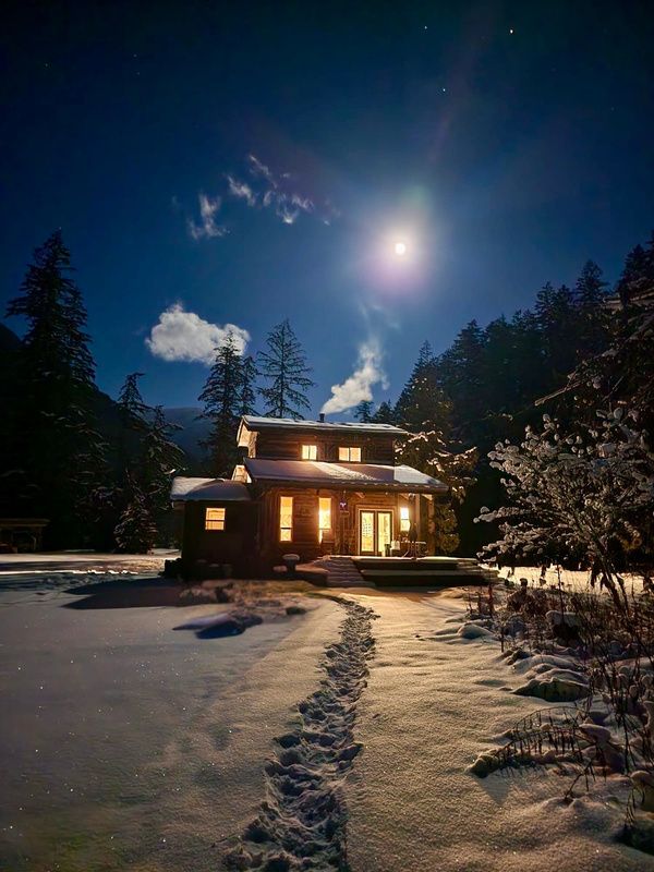 The Main House glowing warmly beneath a moonlit sky