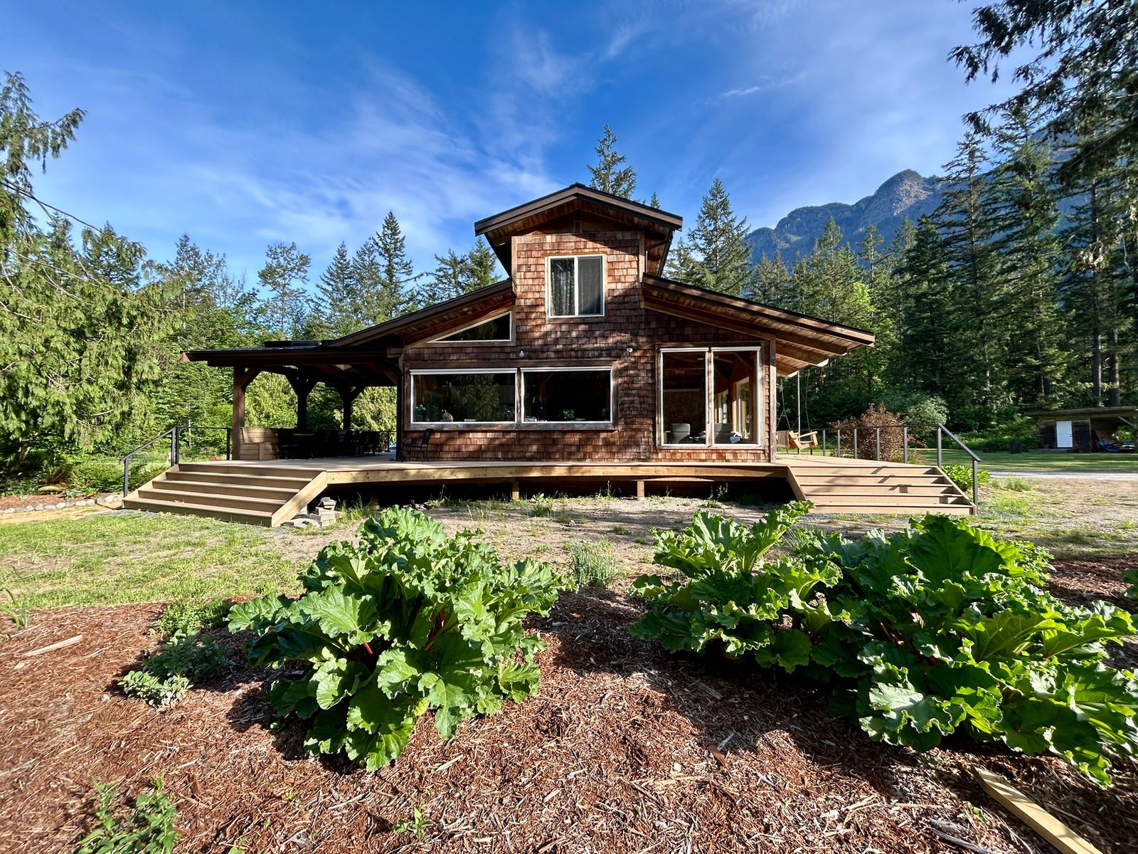 The log-built Main House framed by mountains