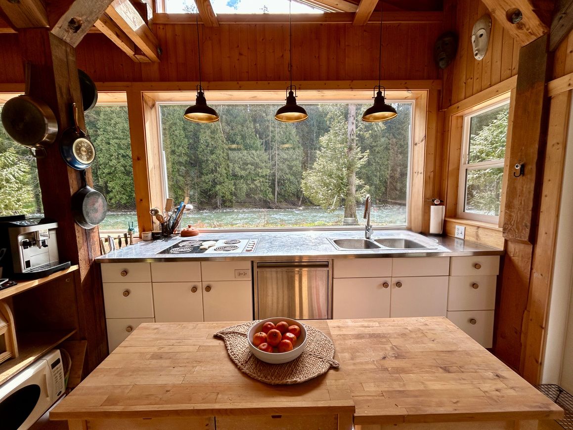The Main House kitchen with wood cabinetry and river views