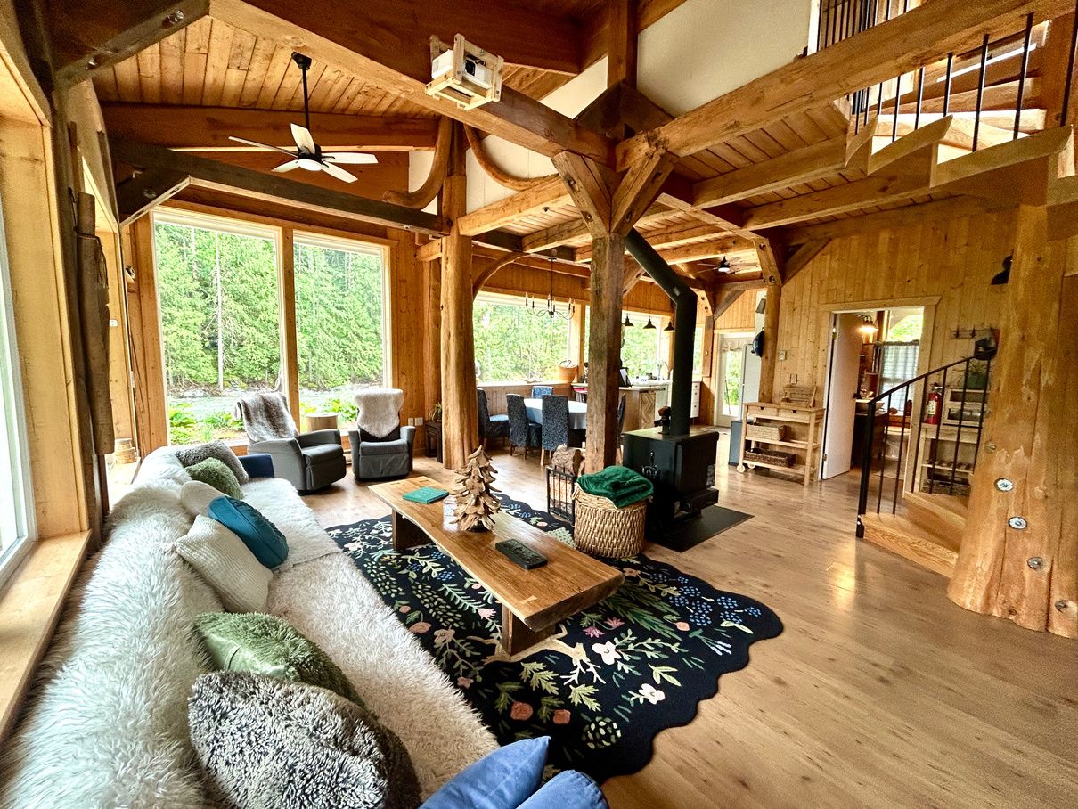 The open timber-frame living room of the Main House