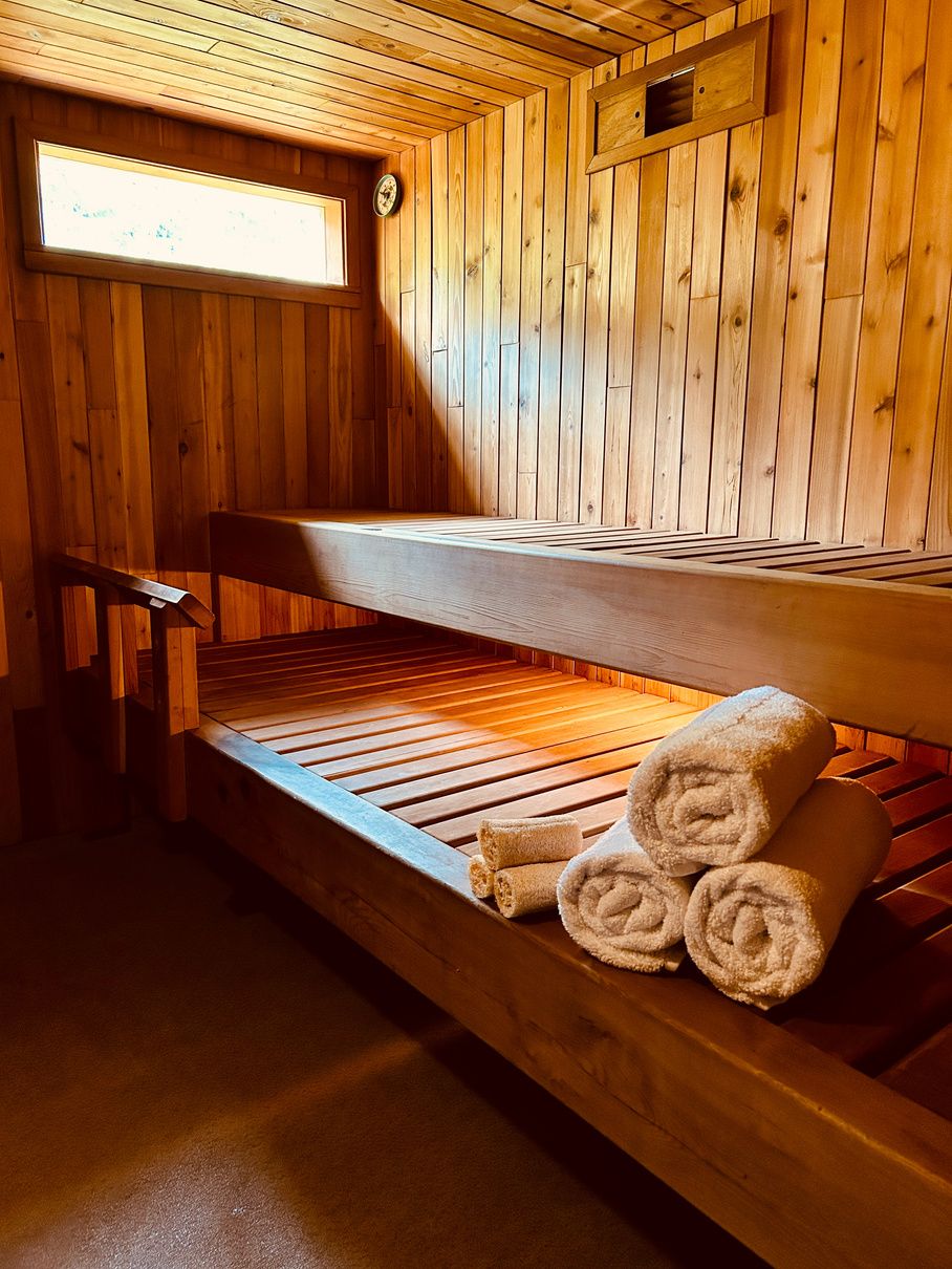 Cedar benches and towels inside the wood-fired sauna